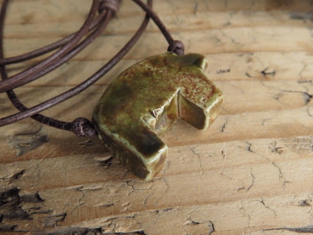 Unikatowy wisior „Miś ze Ślęży” w szkliwie zielono-brązowym – słowiański amulet z gliny, ręcznie wykonany, na regulowanym rzemyku.