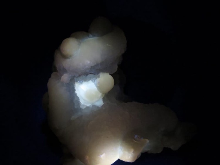 Chalcedon – naturalna konkrecja z Maroka o nieregularnym kształcie, wykazująca fluorescencję w świetle UV.